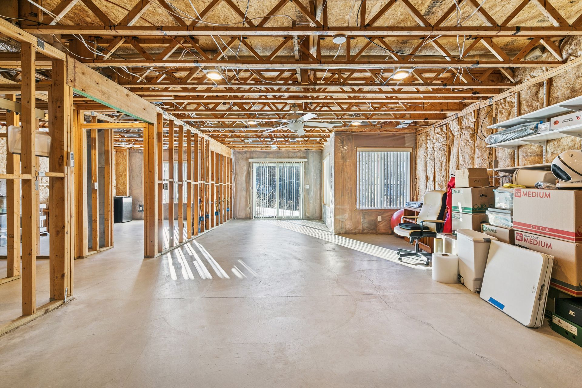 Unfinished lower level provides additional space ready for a second bedroom, and bathroom